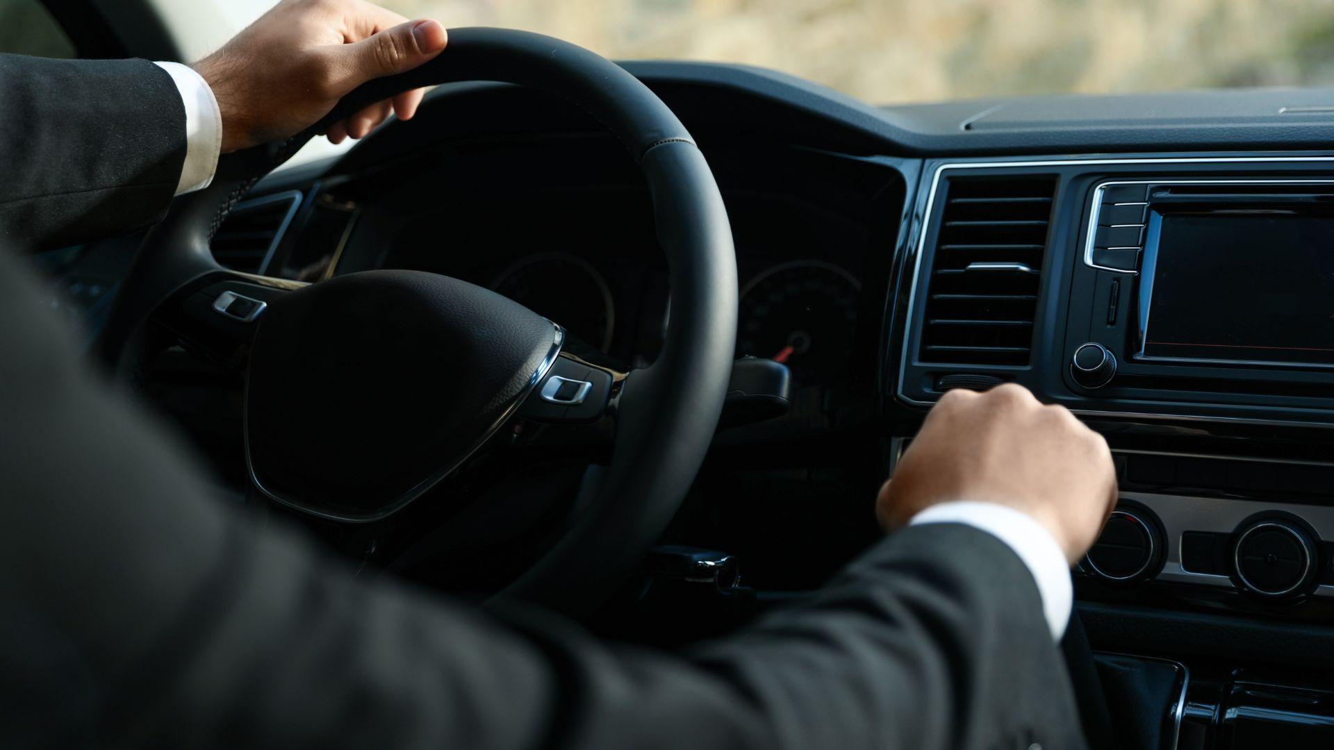 Professional chauffeur at the wheel of a luxury sedan in Chicago